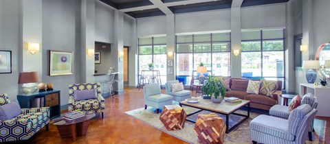 a living room filled with furniture and large windows